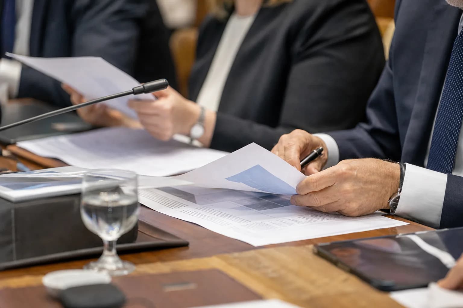 אולם דיונים ממשלתי בירושלים במהלך הצגת תוכנית טכנולוגית, משתתפים מעיינים במסמכים מודפסים
